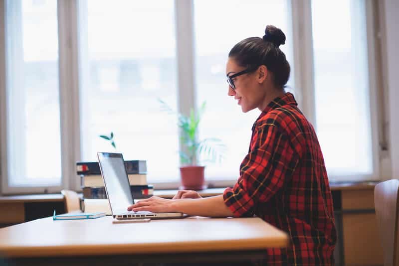 Woman at table working on laptop