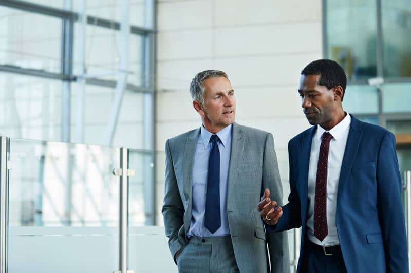 two men walking and talking