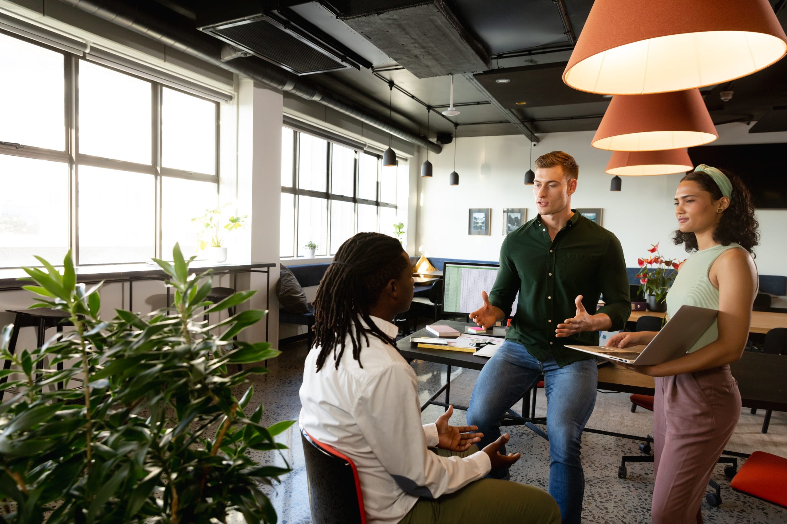 Caucasian manager discussing with multiracial colleagues in meeting at office. Unaltered, creative business, workplace, meeting, strategy, teamwork, diversity.