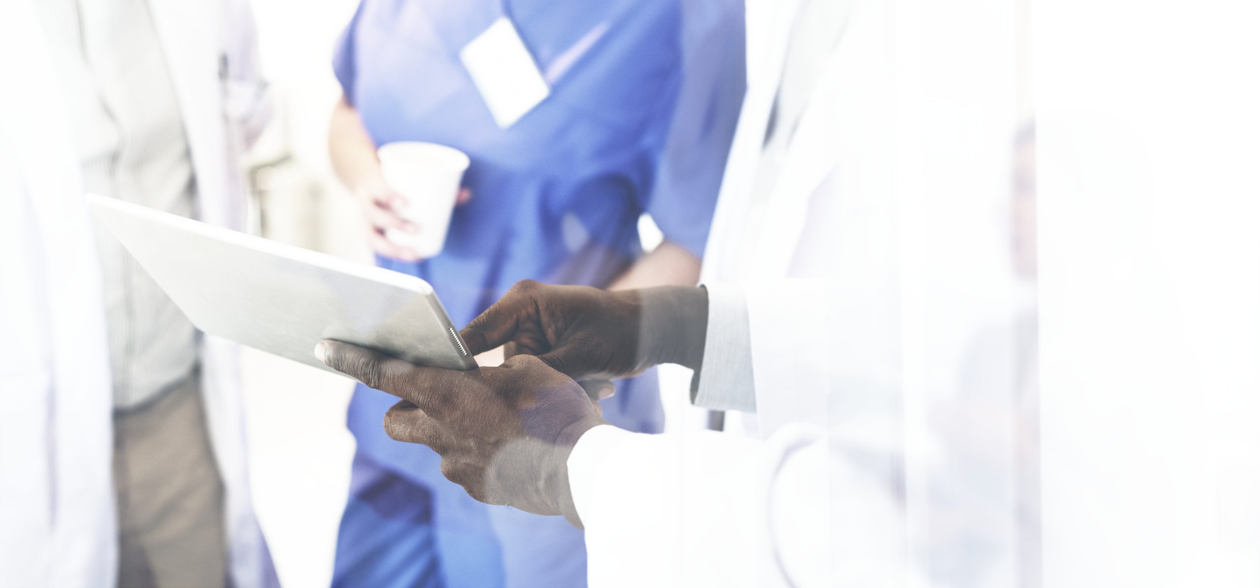 Group of doctors having a discussion over a digital tablet